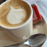 Oat milk latte served with biscoff biscuit  at Lagom Bakery & Eatery in Glasgow