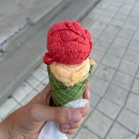 Sour cherry apricot ice cream in a green cone  at G&S Eiswelt in Sassnitz