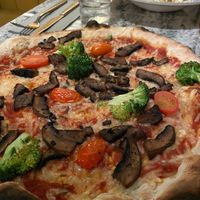 MARGARITA VEGANA Herb-infused tomato sauce, vegan mozzarella, marinated cherry tomatoes, fresh basil -With added roasted broccoli and garlic-roasted portabello mushroom. at V Italiano Moderno in Malmo