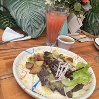 The menu of the day with strawberry water, it’s a Soy chorizo-stuffed chile relleno with green sauce and cambray potatoes.  at El Jardín de Azu in Queretaro
