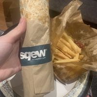 Falafel wrap with a portion of chips  at Sqew Shawarma Bar in Leeds