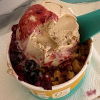 Peanut butter ice-cream on top, pistachio hiding at the bottom, caramelised biscuit crunch and a berry fruit coulis - it’s still settling as I write!  at Yole in Valletta