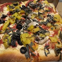 10” Vegan grandma pizza with half olives/banana peppers and half mushrooms/pineapple with thin julienned slices of fresh basil on top. (The basil gave a really nice pop of flavor at Genova Pizza in Audubon