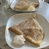 Plant-based lemon sugar crepe in front, vegetarian tiramisu crepe in back.   at Canela Crepes & Coffee in Toronto