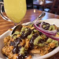 samosa chat appetizer without raita, and vegan golden milk in the background    at Mela in Asheville
