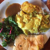 Kale salad, veg curry, Pakora, tamarind chutney, and naan. at Mela in Asheville