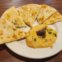 Roasted red pepper hummus and pita bread at Kalamaki Greek Eatery in Anna