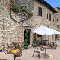 Outdoor seating with stunning views at Dulcisinfundo in San Gimignano
