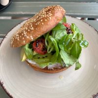 Avocado toasted bagel with vegan cream cheese, dressed tomato and leaves. Yum! 🤭  at Rütz - Albufeira in Albufeira