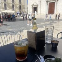Olives, cocktail and ‘fried beans’ (broad beans snack).  at Caffè del Borgo in Bari