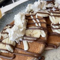 Vegan pancakes with Nutella, banana, and vegan whipped topping   at The Taste of Home in Trieste