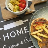 Fresh fruit with honey drizzle and peach Nutella vegan pancakes .  at The Taste of Home in Trieste