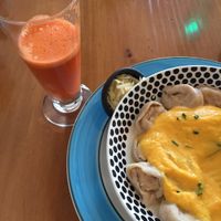 Carrot ginger juice and walnut/cheese ravioli in pumpkin garlic sauce (sorry, mid-meal!). Seasonal autumn menu. at El Living in Puerto Natales