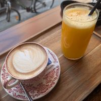 Cappuccino with oat milk and a fresh pressed orange juice at M'kanda in Shkoder