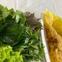 Bánh Xèo with huge pile of herbs, also some dipping condiments, peanuts, $4, could share between 2. at Magnolia Veggie Restaurant in Phnom Penh