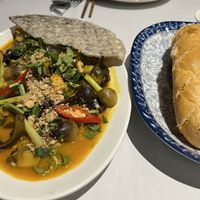 - stir fried mushroom with tofu, coconut milk, peanuts, wafer, and a baguette (Vietnamese custom)  at Magnolia Veggie Restaurant in Phnom Penh