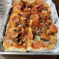 Meat lovers pizza with generous toppings at Bloom Kitchen & Co in Oxford