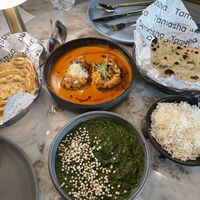 Top right = butter chicken and garlic naan (not vegan) and Dakhni Saag with Flaky Laccha Paratha bread (both vegan)  at Tamasha  in Raleigh