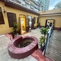 Outdoor courtyard with seating area behind me  at 日Rise in Macau