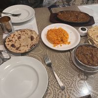 Of these, the vegan are: biryani, roti bread and aubergine curry in metal bowl  at Ellora Indian Restaurant  in Kyoto