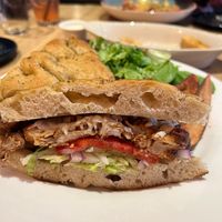 The Wheat Penny ‘Burger’, made vegan. Crispy cauliflower patty 🤤 on focaccia bread, with melty vegan cheddar, lettuce, onion tomato and pickles. So good and filling!  at Wheat Penny Oven and Bar in Dayton
