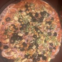 Fiery pizza- no cheese with olives, capsicum ( pepper), chili pepper, chili flakes, sweet corn, onion and swapped kocchi for pineapple  at MozzarElla By Nero Kitchen in Ella