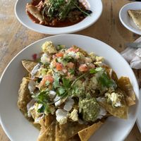 Lasagna (back) came with delicious rosemary sourdough and the chilaquiles (front) were so delicious!!!  at Sage Bistro - Cloud Kitchen in Culver City