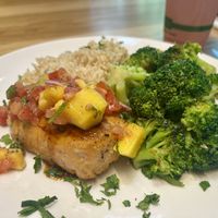 Salmon filet with teriyaki/mango sauce, and sides of brown rice and broccoli   at Veggie Grill by Next Level - Downtown in Seattle
