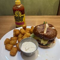Ghost pepper jalapeño cheeze burger with added yellow bird sauce and tater tot’s   at Veggie Grill by Next Level - Downtown in Seattle