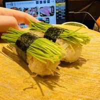 There are bonito flakes under the onions  at Mawashizushi Katsu  in Tokyo
