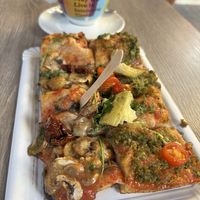 They cut the pizza (paid by weight) in little squares 🥲 pesto pizza + mushroom pizzaa  at La Fermata de Sarrià in Barcelona