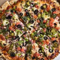 Vegan pizza with sesame crust, vegan cheese and loads of veggies   at Red Swan Pizza in Hamilton