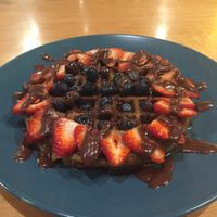 Waffles with blueberries and strawberries  at Raw Cafe in Lima