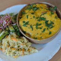 Potato Casserole. Filled with baked broccoli, mushrooms and soy meat. at Avocado Vegan Bistro in Gdansk