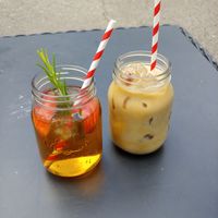 Apple juice (left) and iced coffee (right). The apple juice had two apple slices and a sprig of rosemary in it :) at Old School Cafe in Bury St Edmunds