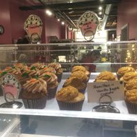 Cupcakes behind glass at Get Caked Bakery in Rochester