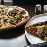 Vegan kebab pizza in a whole wheat base with vegan cheese, pineapple, onions, spinach, artichoke and mushrooms. The sliver wrap is a vegan durüm/wrap whole wheat vegan ham lettuce tomatoes pepper and cucumber. at Express Pizza in Copenhagen