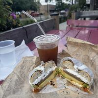 The breakfast sandwich and a iced coffee on the patio   at R&A Sourdough in Chicago
