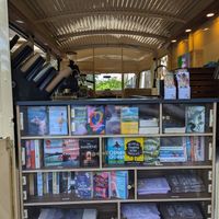Bookshelves - all secondhand - and a few merch items at Journey Coffee & Books in Bern