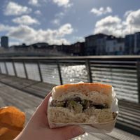 My focaccia sandwich sat on the boardwalk near hapenny bridge  at Twist Artisan Bakery in Dublin
