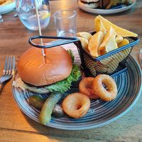 Moving mountains burger with chunky chips & onion rings. at The Seacroft in Holyhead