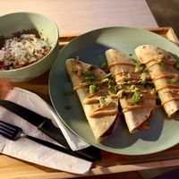 Quesadilla trio, one jackfruit, one gyro “meat” and one falafel. Comes with a side Greek salad   at Just Falafel Vegan Cafe in Houston