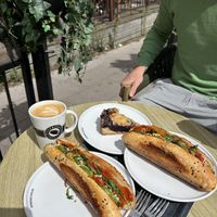 Warm vegan sandwich, vegan blueberry cake amd flat white with oat milk  at Espresso House in Ystad