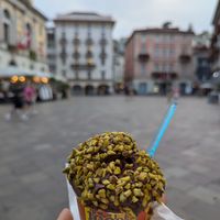 Vegan dark chocolate gelato with pistachio topping at Gelateria Chocolat in Lugano