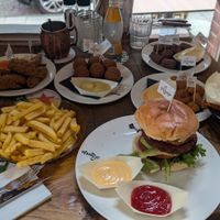 My vegan burger and chips in the foreground at Loetje in Bergen
