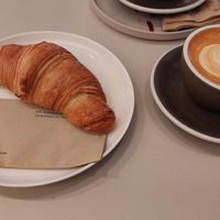 Oat cappuccino and vegan croissant at Ombak Coffee in Aarau