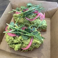 Smashed Pea and Avocado Toast with added pickled onions  at Roots 2 Rise in Larchmont