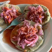 A Spinach, a pumpkin, and a black been Pupusa each topped with curtido and habanero salsaa  at Waruguma in San Pedro