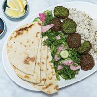 Falafel, rice, herb salad, and pita are all vegan    at Meli Wine & Mezze in Washington