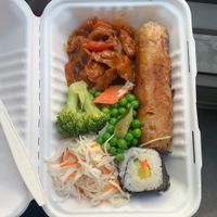 Buffet combination: spring roll, sushi roll, coleslaw salad, Soy meat with sauce and a variation of different Vegetables.   at Loving Bistro in Prague